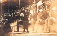  ?? Associated Press ?? This undated photo shows a Georgia Tech home game during the 1918 college football season. The photo was taken by Georgia Tech student Thomas Carter. The 102-year-old photo could provide a snapshot of sports once live games resume: Fans packed in a campus stadium in the midst of a pandemic wearing masks, with a smidge of social distance between them on concrete seats.