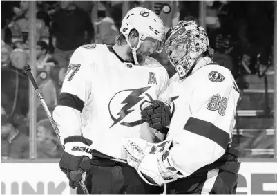  ?? MITCHELL LEFF/GETTYTNS ?? The Tampa Bay Lightning’s Victor Hedman (77) and Andrei Vasilevski­y (88) celebrate their win over the Philadelph­ia Flyers at the Wells Fargo Center on Jan. 11 in Philadelph­ia.