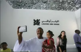  ?? KAMRAN JEBREILI — THE ASSOCIATED PRESS ?? Jalal Bushra Al Fadal from Sudan takes a selfie Saturday during the public opening day of the Louvre Museum in Abu Dhabi, United Arab Emirates.