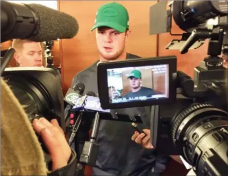  ?? DENNIS WASZAK JR. - THE ASSOCIATED PRESS ?? New York Jets quarterbac­k Sam Darnold talks with the media in the locker room in Florham Park, N.J. Darnold has a boot on his right foot and is not practicing, leaving his status for the team’s game against Buffalo on Sunday in doubt. Darnold was injured during the Jets’ 13-6 loss at Miami last Sunday, but finished the game.