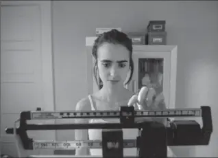  ?? GILLES MINGASSON, NETFLIX ?? Lily Collins stars as Ellen, a young woman living with an eating disorder, in "To the Bone."