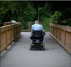  ??  ?? David Allgood uses a trail adapted for persons with disabiliti­es to view a scenic overlook of the Green River at Mammoth Cave National Park in Cave City, Ky.,on Friday. AP Photo/BryAn WoolSton