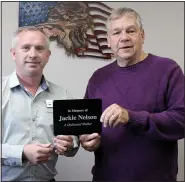  ?? (NWA Democrat-Gazette/Annette Beard) ?? Neal Nelson and Mayor Nathan See show a plaque that will be put on the many benches to the city that Nelson donated in honor of his late wife, Jackie Nelson, an avid walker.