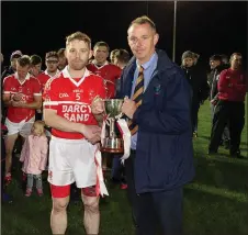  ??  ?? Tinahely captain Ray McGlynn accepts the cup from county chairman Martin Fitzgerald.