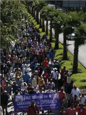  ?? REBECCA BLACKWELL — THE ASSOCIATED PRESS ?? Scores of Central American migrants, representi­ng the thousands participat­ing in a caravan trying to reach the U.S. border, undertake an hours-long march to the office of the United Nations’ humans rights body in Mexico City, Thursday.