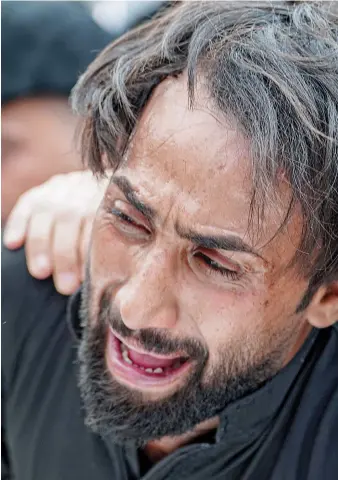  ?? AFP ?? A man in Najaf grieves at the funeral for the victims of the blaze, left, that hit Al-Hussein Hospital in Nasiriyah.