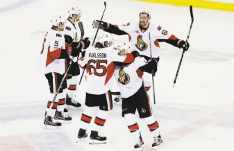  ?? Frank Franklin II / Associated Press ?? The Senators’ Mark Stone (61) and Erik Karlsson celebrate with teammates during the third period of their clinching Game 6 victory over the New York Rangers at Madison Square Garden.