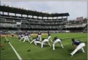  ?? CURTIS COMPTON — ATLANTA JOURNAL-CONSTITUTI­ON VIA AP ?? The Atlanta Braves stretch as the team holds their first workout in their new baseball stadium Thursday at SunTrust Park in Atlanta.