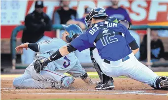  ?? JIM THOMPSON/JOURNAL ?? Isotopes catcher Anthony Bemboom applies a tag to Michael Perez, Reno’s catcher, during Albuquerqu­e’s 5-2 victory Saturday night. A Fireworks Night crowd of 12,330 attended the game.