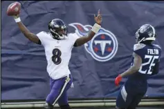  ?? Associated Press ?? LONG RUN — Baltimore Ravens quarterbac­k Lamar Jackson (8) celebrates after scoring a touchdown on a 48-yard run against the Tennessee Titans in the first half of an NFL wildcard playoff football game on Sunday in Nashville, Tenn. At right is Titans cornerback Kristian Fulton (26). The Ravens won 20-13.