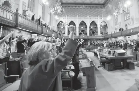  ??  ?? Green Party Leader Elizabeth May raises her fist during a Daughters of the Vote event, organized by Equal Voice Canada, in the House of Commons on Wednesday. The event brings together 338 DOV delegates — each woman representi­ng a federal constituen­cy...