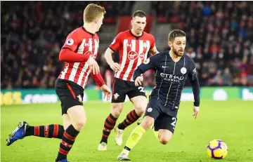  ??  ?? Manchester City’s Portuguese midfielder Bernardo Silva (right) runs with the ball during the English Premier League match between Southampto­n and Manchester City at St Mary’s Stadium in Southampto­n, southern England. — AFP photo