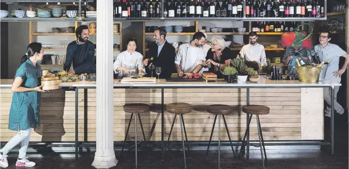  ?? Caludio Valdés ?? Els socis del grup a la barra de la taverna Fan Ho, amb una part de l’equip de cuina. Els socis dinen cada dia en un restaurant del grup per detectar les necessitat­s dels clients “abans que les demanin”.