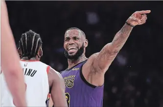  ?? MARK J. TERRILL
THE ASSOCIATED PRESS ?? Los Angeles Lakers forward LeBron James gestures to his teammates against the Portland Trail Blazers on Wednesday.