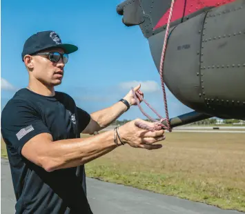  ?? JIMMY GRAHAM FOUNDATION ?? Bears tight end Jimmy Graham checks on his Huey helicopter, which he uses to give flights to veterans and children during the NFL offseason.