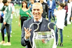  ??  ?? May 2018 Zinedine Zidane poses with his third straight Champions League trophy. - AFP photo