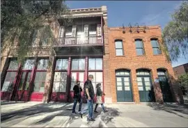  ?? Mel Melcon Los Angeles Times ?? PEOPLE WALK by the Chinese American Museum in downtown L.A. on Oct. 21. The site was central to the racial violence in 1871 that left 18 Chinese people dead.