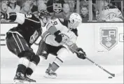  ?? Luis Sinco Los Angeles Times ?? THE DUCKS’ Antoine Vermette, right, battles the Kings’ Dustin Brown in the teams’ game last week.