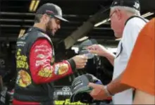  ?? THE ASSOCIATED PRESS ?? NASCAR driver Martin Truex Jr., left, signs an autograph for a fan before a practice session Saturday in Watkins Glen, N.Y.