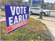  ?? AP PHOTO/JEFF AMY ?? A sign in an Atlanta neighborho­od urges people to vote early in Georgia’s two U.S. Senate races in December.