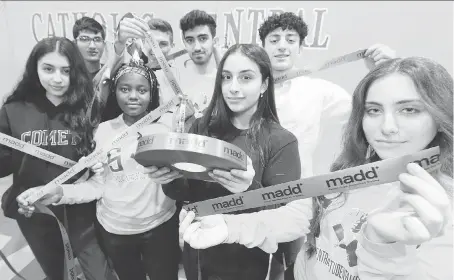  ?? NICK BRANCACCIO ?? Catholic Central students Laran Aref, front left, Masika Nzondero, Mariam Ramadan and Rivadin Kazo hold red ribbons with their classmates on Thursday during the launch of MADD Windsor and Essex County Project Red Ribbon Campaign.