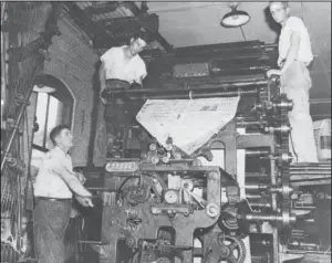  ?? Submitted photo ?? PRESSROOM: From left, Archie Lawler, Houston “Tiny” Smith and Grady Geer work in the pressroom of The Sentinel-Record/New Era building at 912 Central Ave. in 1952. The Garland County Historical Society’s journal, The Record 2018, examines the history of the newspapers and presents the recollecti­ons of Bobby Anderson, who worked as a newspaper boy as he grew up in Hot Springs in the 1950s.