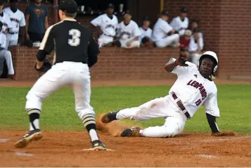  ?? Staff photo by Jerry Habraken ?? n Liberty-Eylau’s Marzavian Riles slides into home plate before Pittsburg’s Brett McGee can receive the ball Friday at Leopard Field at H.E. Markham Park in Texarkana, Texas.