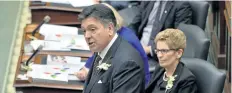  ?? NATHAN DENETTE/THE CANADIAN PRESS ?? Ontario Finance Minister Charles Sousa, left, delivers the Ontario 2016 budget next to Premier Kathleen Wynne, right, at Queen’s Park in Toronto on Feb. 25, 2016.