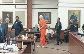  ?? MICHAEL DEWITT JR./USA TODAY NETWORK ?? Alex Murdaugh, in orange jumpsuit, arrives in a courtroom in Beaufort, S.C., on Tuesday morning for his sentencing.