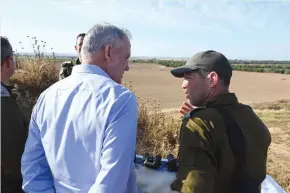  ?? (Defense Ministry) ?? ALTERNATE PRIME MINISTER Benny Gantz and Col. Yoav Bruner discuss the situation in the South yesterday.