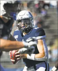  ?? Stephen Dunn / Associated Press ?? UConn quarterbac­k Jack Zergiotis (11) sets to pass during the second half of an NCAA game against Houston on Saturday in East Hartford.