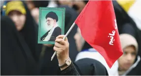  ?? (Nazanin Tabatabaee/Reuters) ?? A WOMAN holds a picture of Ayatollah Ali Khamenei, at an anti-US demonstrat­ion near the old US embassy in Tehran in 2019.