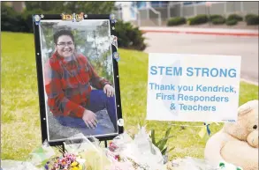  ?? David Zalubowski / Associated Press ?? A photo of student Kendrick Castillo stands amid a display of tributes outside the STEM School Highlands Ranch a week after the attack on the school that left Castillo dead and others injured in Highlands Ranch, Colo.