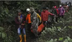  ?? Ardhy Fernando/Associated Press ?? Rescuers carry the body of a victim of the eruption of Mount Marapi on Tuesday in Batu Palano, West Sumatra, Indonesia. Rescuers searching the hazardous slopes of the volcano found more bodies of climbers who were caught by a surprise weekend eruption.