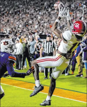  ?? Vasha Hunt
The Associated Press ?? Alabama wide receiver Isaiah Bond prepares to make a 31-yard TD catch against Auburn cornerback D.J. James with 32 seconds left in the Crimson Tide’s 27-24 victory Saturday at Jordan-hare Stadium.