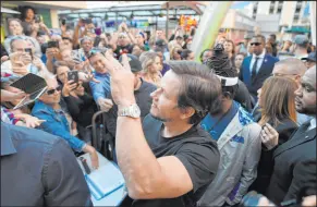  ?? Sam Morris
Las Vegas News Bureau ?? Mark Wahlberg waves to fans as he arrives at a VIP event at Wahlburger­s Las Vegas in the Grand Bazaar Shops at Bally’s in 2017.