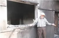  ?? (Tovah Lazaroff) ?? RASHID DAWABSHA stands outside his son Mamoun’s torched home in the Arab village Duma on Sunday.