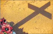  ?? AFP ?? The shadow of a cross from a Covid-19 victim’s grave is seen at the Nossa Senhora Aparecida cemetery in Manaus, Brazil.