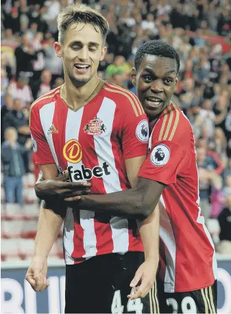  ??  ?? Joel Asoro hugs Adnan Januzaj as Sunderland celebrate the on-loan winger’s winner against Shrewsbury