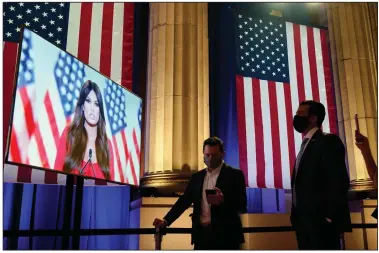  ?? (AP/Susan Walsh) ?? Donald Trump Jr. (right) watches Monday as his girlfriend, Kimberly Guilfoyle, tapes her speech for the first night of the Republican National Convention from the Andrew W. Mellon Auditorium in Washington.