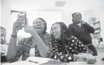  ?? KAITLIN MCKEOWN/STAFF FILE ?? Sixth-grade students Zymiah Corprew, from left, Diavian Lewis and
Kristie Porter react as a team of classmates attempts to launch rockets constructe­d of paper during a class at Portsmouth’s Brighton Elementary School in 2019.