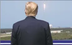  ?? Alex Brandon / Associated Press ?? President Donald Trump views the SpaceX launch to the Internatio­nal Space Station on Saturday in Cape Canaveral, Fla.