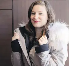  ??  ?? Justine Decaenes, Project Leader at CTT Group, models a heated coat, after presenting at a Smart Apparel Event in Toronto.