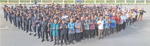  ??  ?? Lee (centre, front row), invited guests and police personnel give their thumbs-up on their special day.