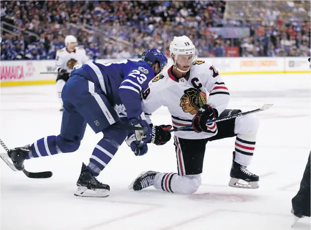  ?? MICHAEL PEAKE / TORONTO SUN / POSTMEDIA NETWORK ?? Chicago captain Jonathan Toews battles Toronto’s Eric Fehr Monday at the Air Canada Centre. The Leafs beat the Blackhawks 4-3 in overtime.