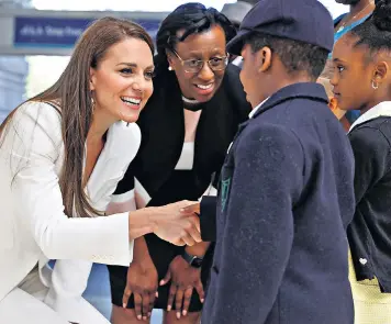  ?? ?? The Duchess of Cambridge meets children at Waterloo Station in London at the unveiling of the National Windrush Monument (left)
