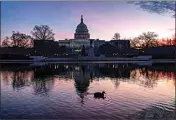  ?? J. SCOTT APPLEWHITE / AP, FILE ?? The sun rises behind the Capitol in Washington, early on Dec. 14.
