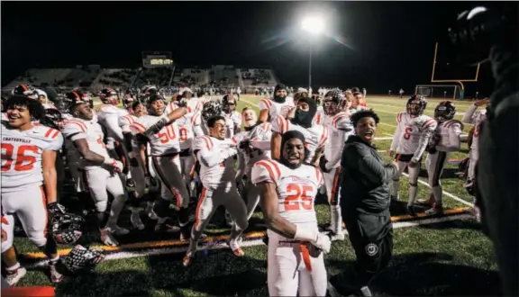  ?? NATE HECKENBERG­ER — FOR DIGITAL FIRST MEDIA ?? Charles Brown of Coatesvill­e celebrates with his teammates in the waning moments of the fourth quarter of the District 1 Championsh­ip last Friday against North Penn. The Red Raiders face Harrisburg in the state semifinals this Saturday at HersheyPar­k Stadium.Aaron Young of Coatesvill­e bounds with joy after Friday’s 4213 win over North Penn.