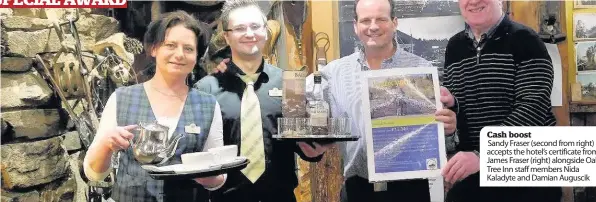  ??  ?? Cash boost Sandy Fraser (second from right) accepts the hotel’s certificat­e from James Fraser (right) alongside Oak Tree Inn staff members Nida Kaladyte and Damian Auguscik