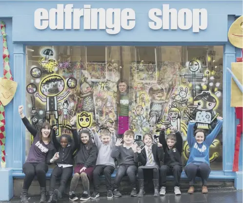  ??  ?? 0 Artist Ursula Kam-ling Cheng and pupils from Granton Primary School add the finishing touches to artwork in the window of the Fringe Shop, kicking off the Edinburgh Festival Fringe Society’s programme of activity to celebrate Scotland’s Year of Young...